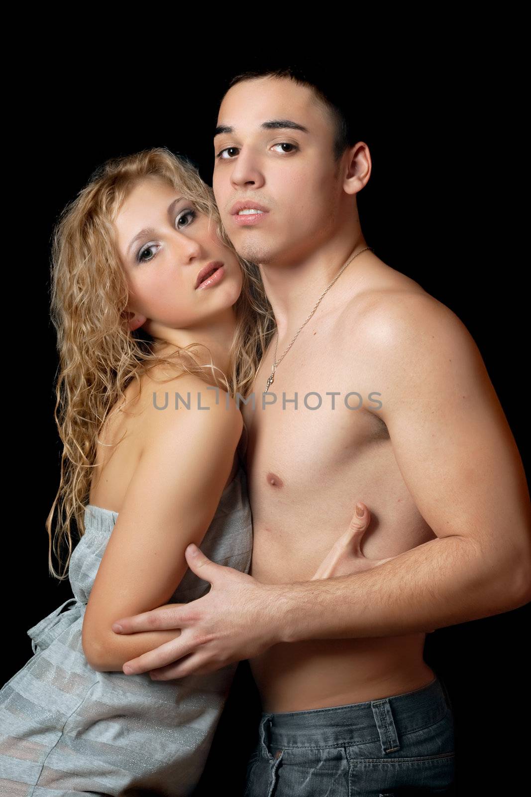 Portrait of a passionate attractive young couple. Isolated on black