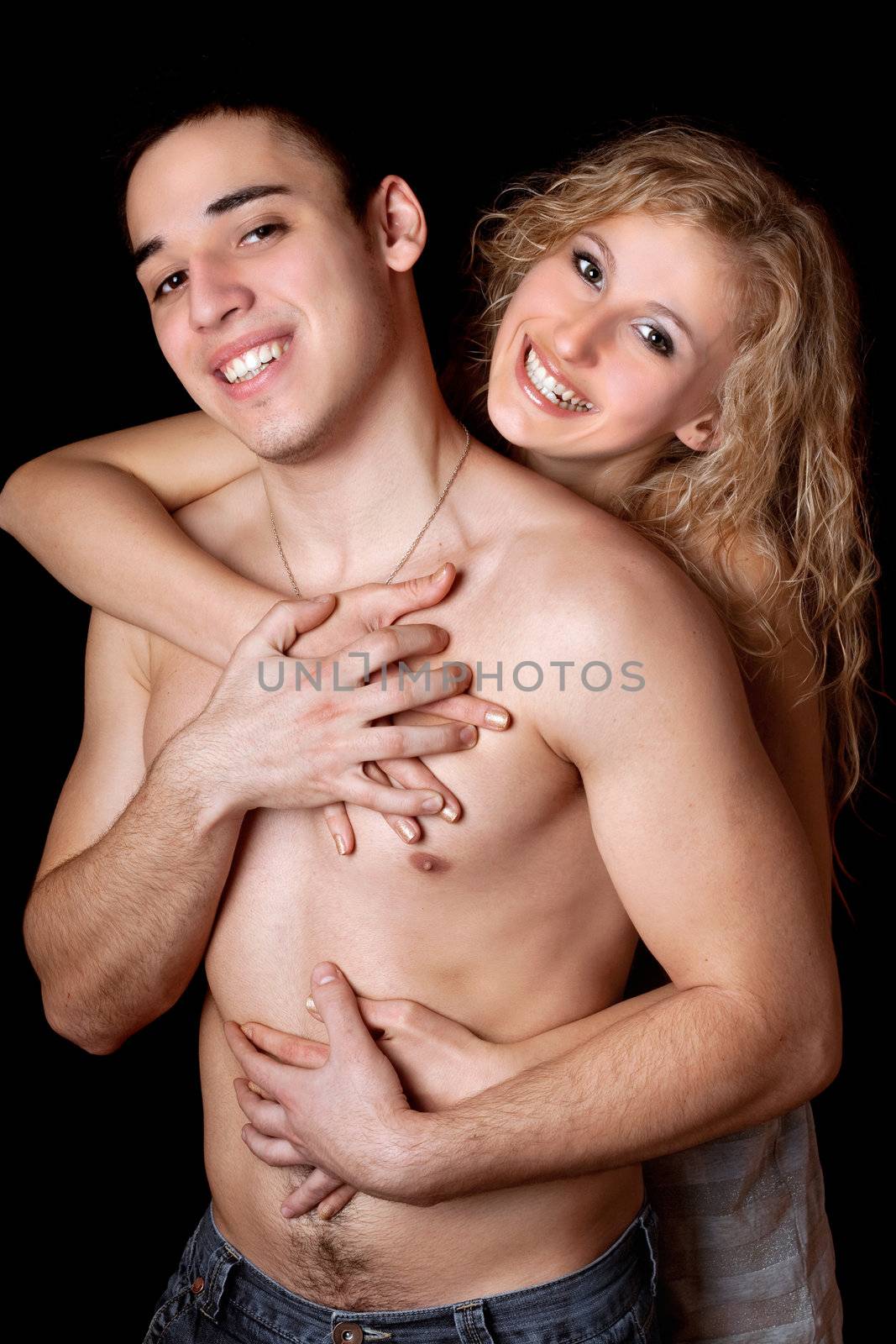 Portrait of happy young couple. Isolated on black background