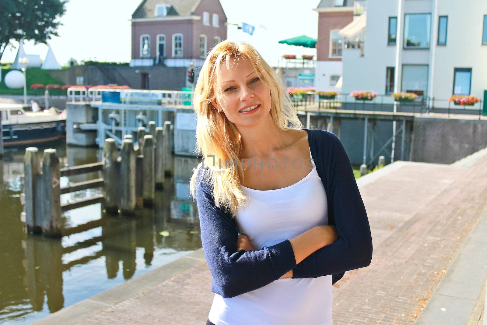 Girl on the waterfront in the Dutch town of Gorinchem. Netherlan by NickNick