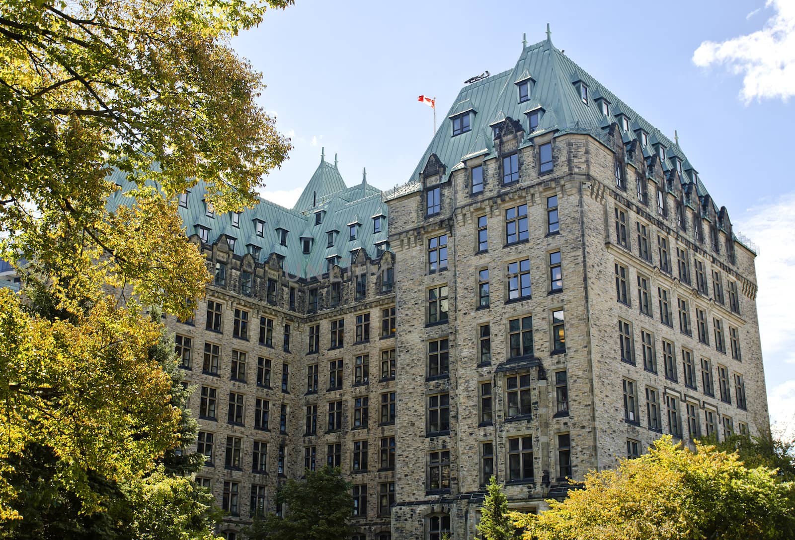 The canadian Parliament Confederation Building shown from behind seeing all three sides.