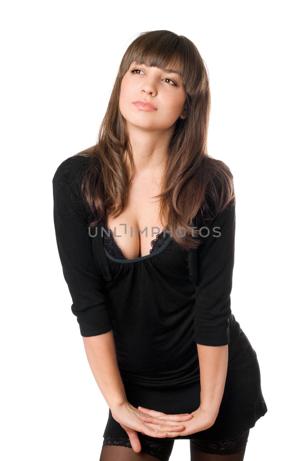 Playful young brunette posing in black dress. Isolated on white