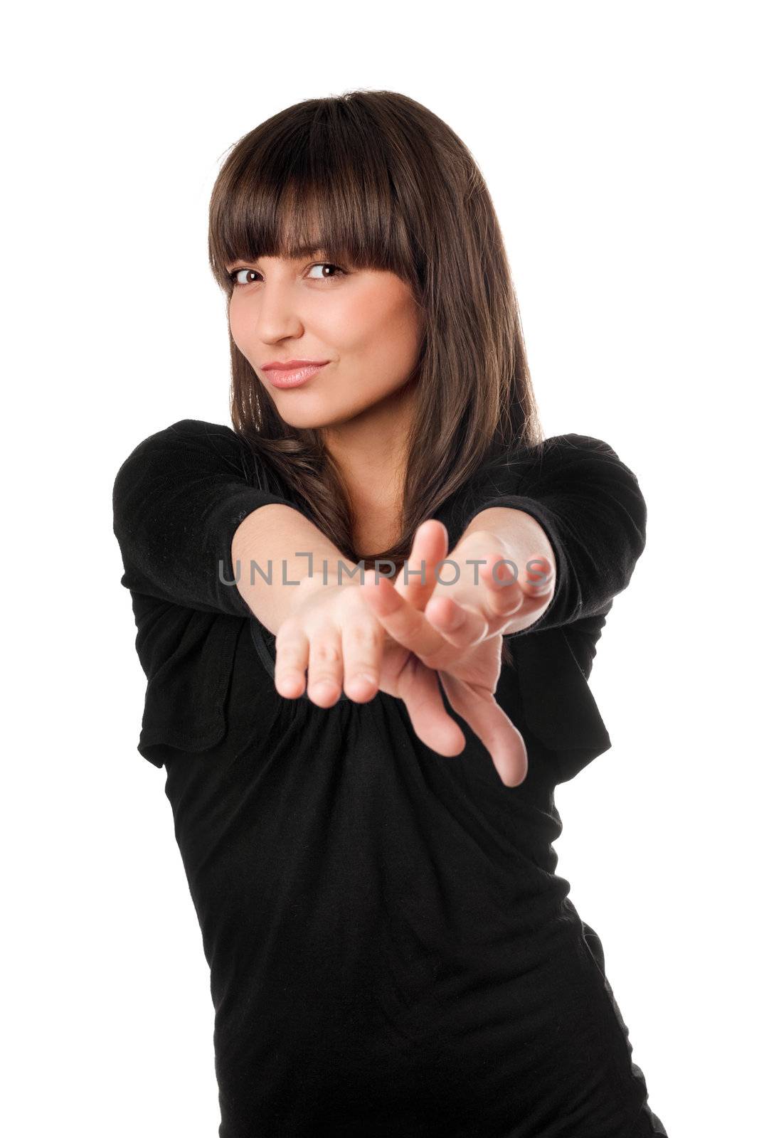 Playful young brunette stretching arms forward. Isolated on white