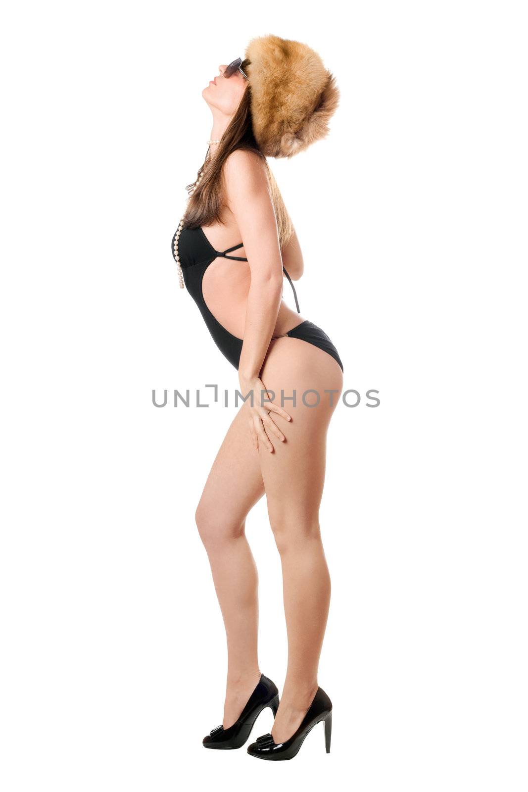 Beautiful lady wearing black swimsuit and fur-cap. Isolated