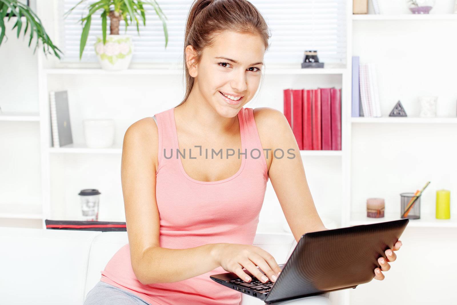 woman smiling while working on laptop at home