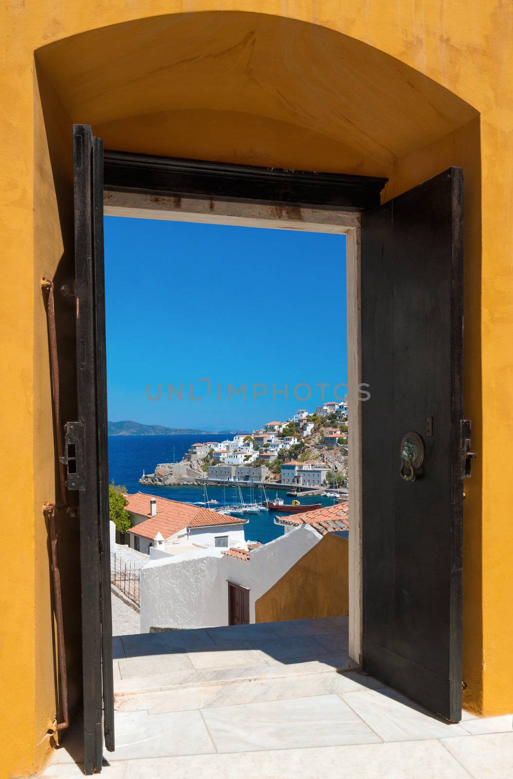 View of the port of the island of Hydra, Greece, as seen through an open door
