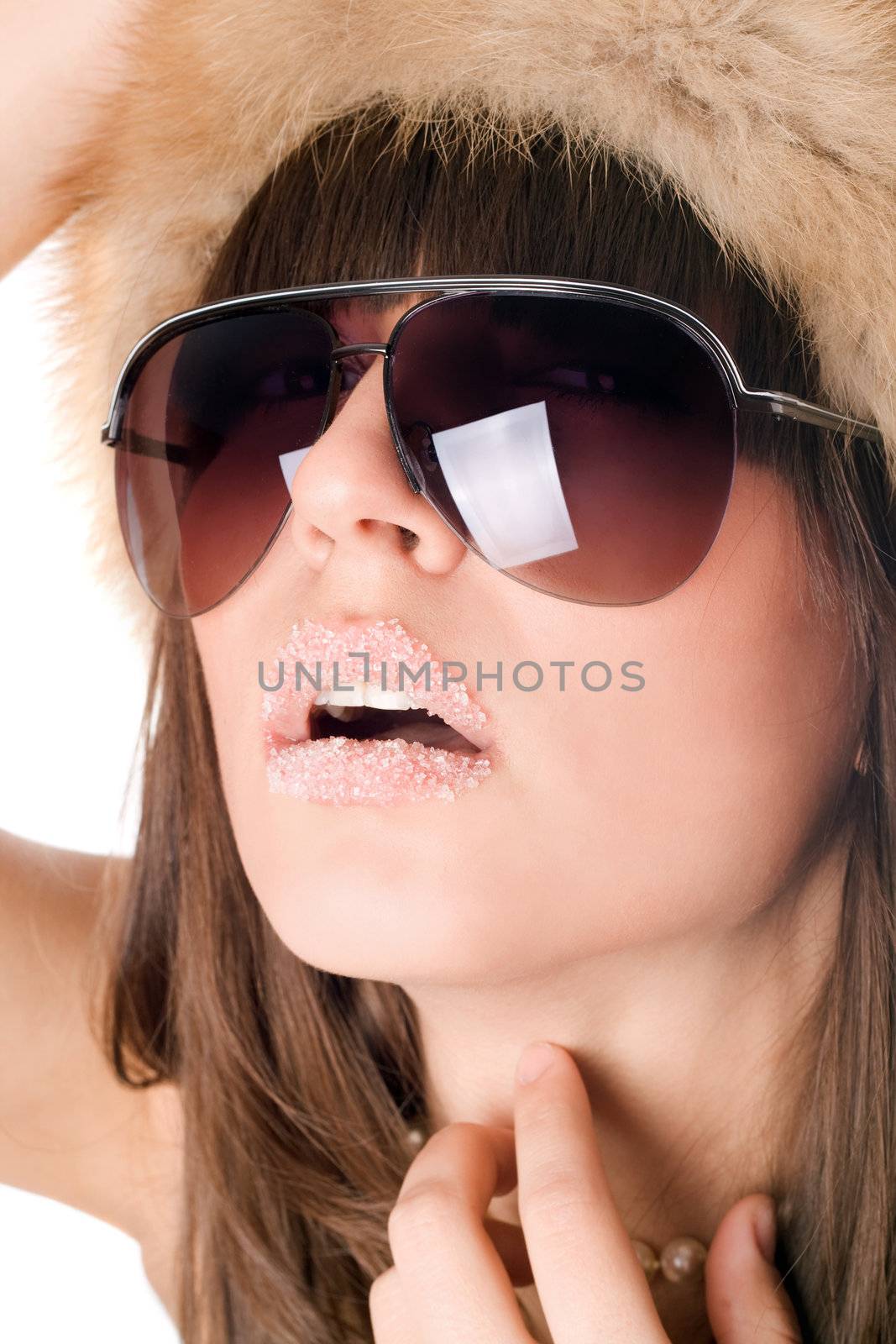 Portrait of sexy woman wearing sunglasses with sugar lips. Isolated