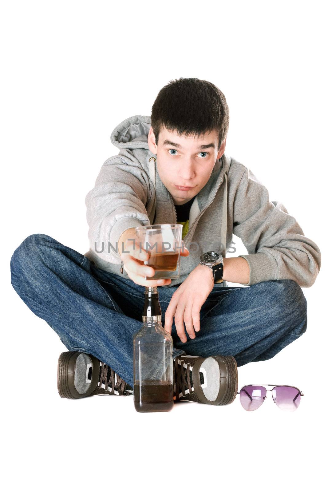 Young man with a glass of whiskey. Isolated