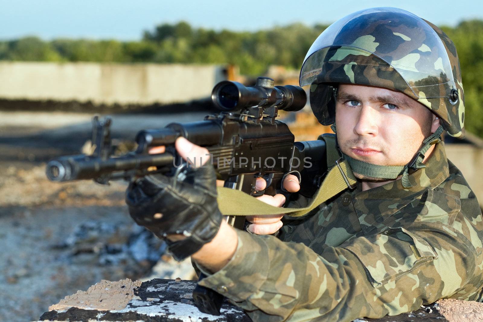 Portrait of the soldier in camouflage with machine gun