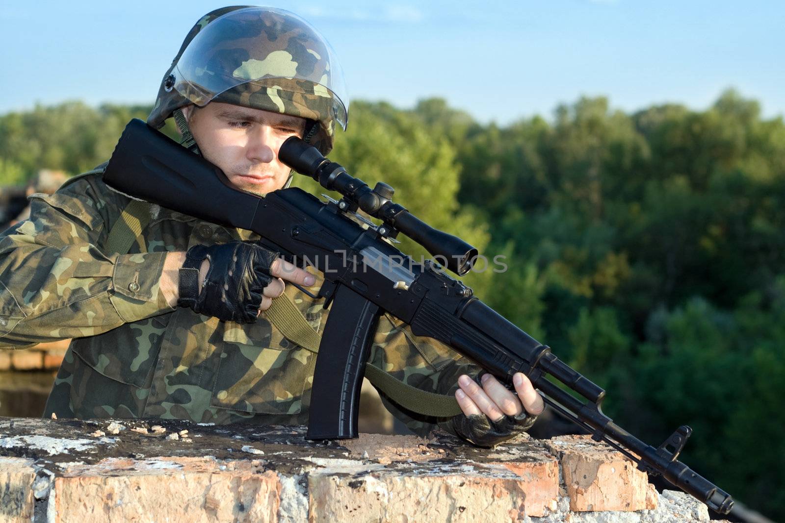 Portrait of sniper in camouflage uniform in action