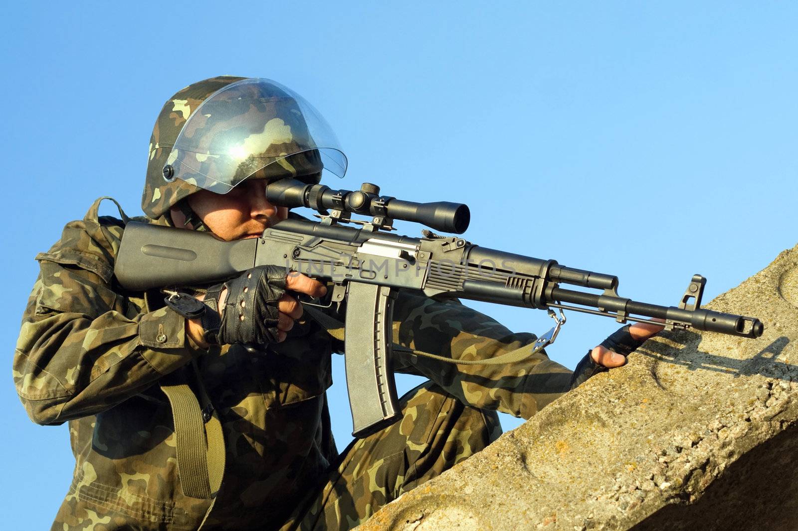 Soldier with machine gun waiting in ambush