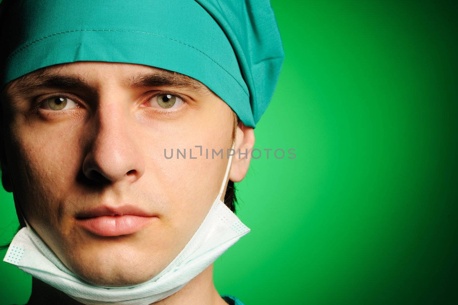 Surgeon with mask over green