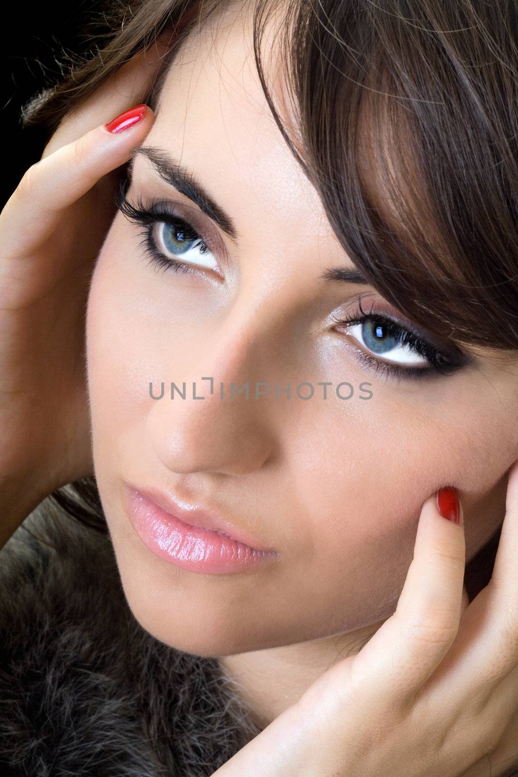 Close-up of attractive brunette. Isolated on black