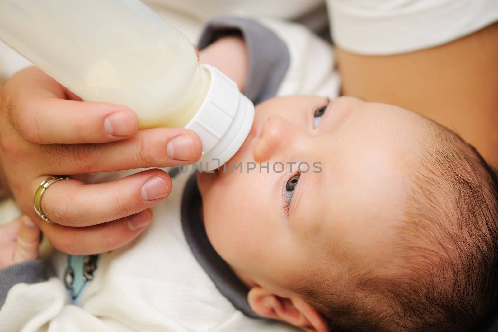Dad feeding his newborn baby