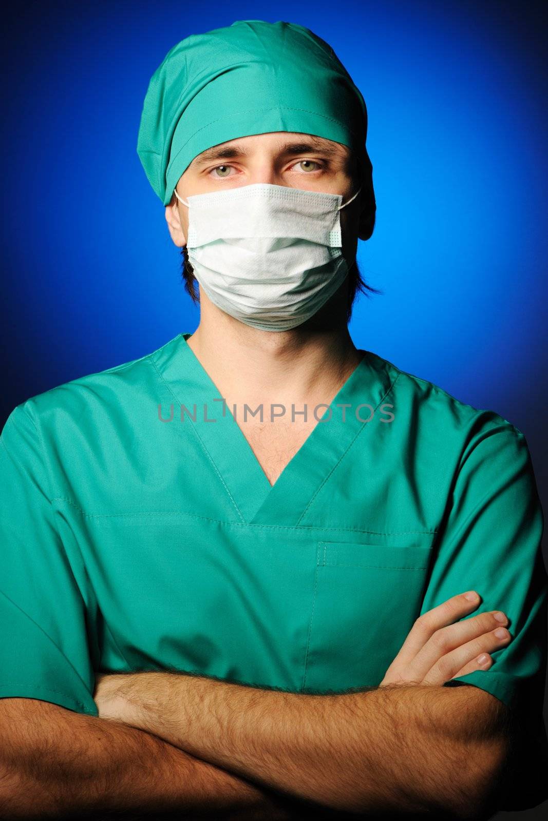 Surgeon in mask over blue