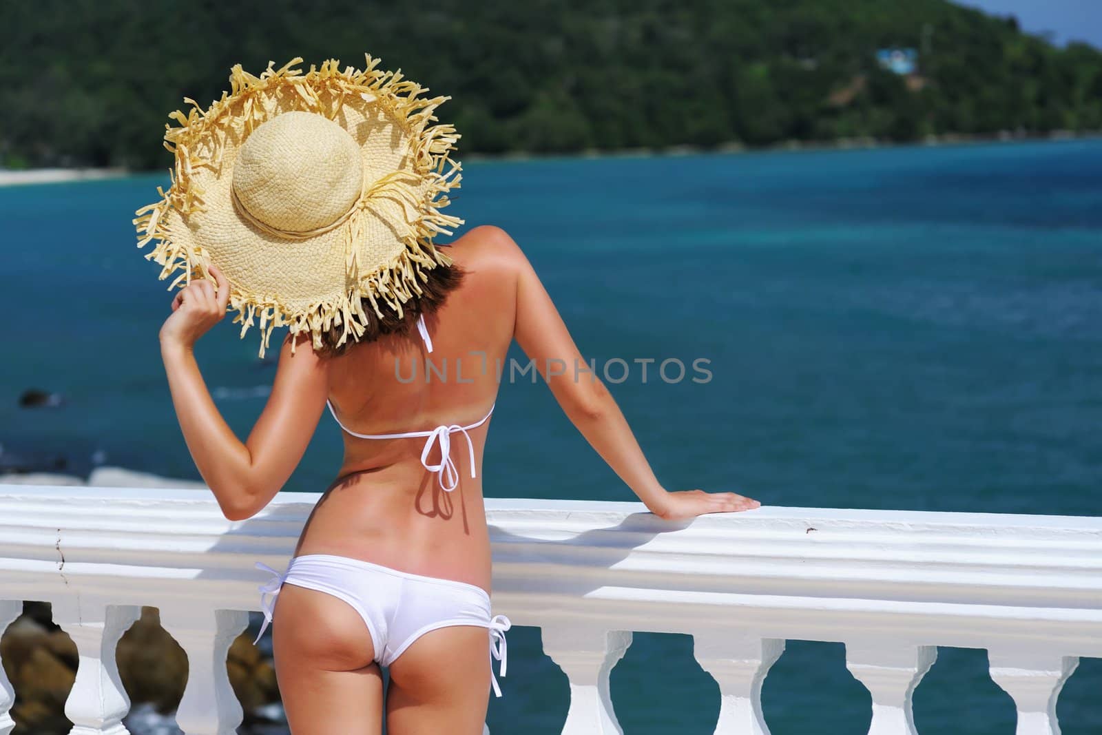 Girl on a tropical resort with hat