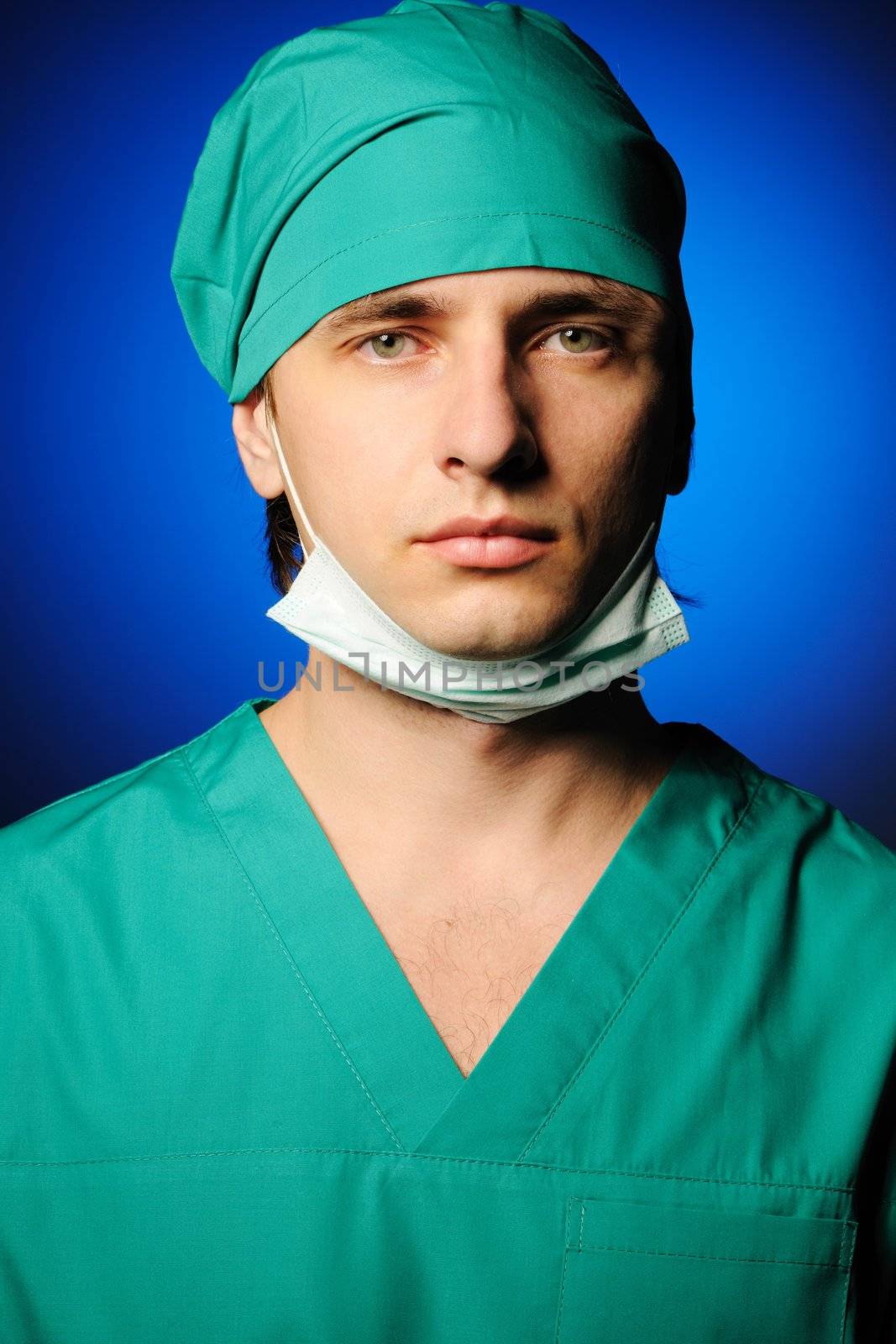 Surgeon with mask over blue