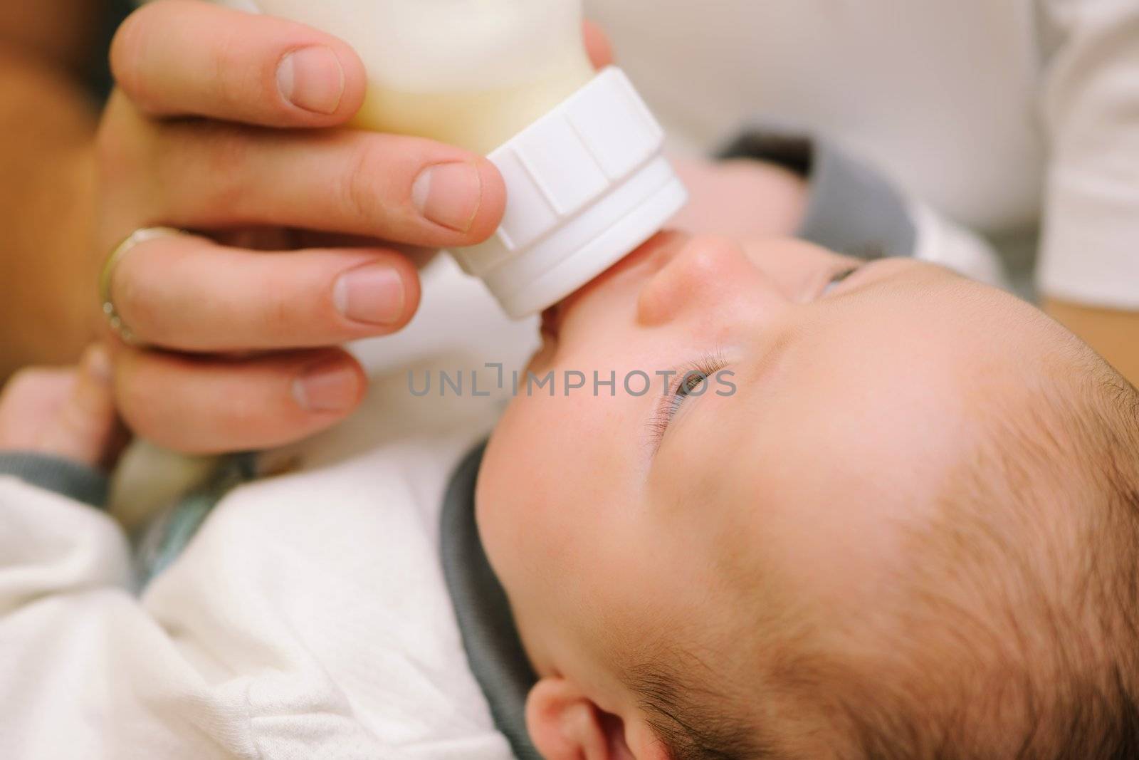 Dad feeding his newborn baby