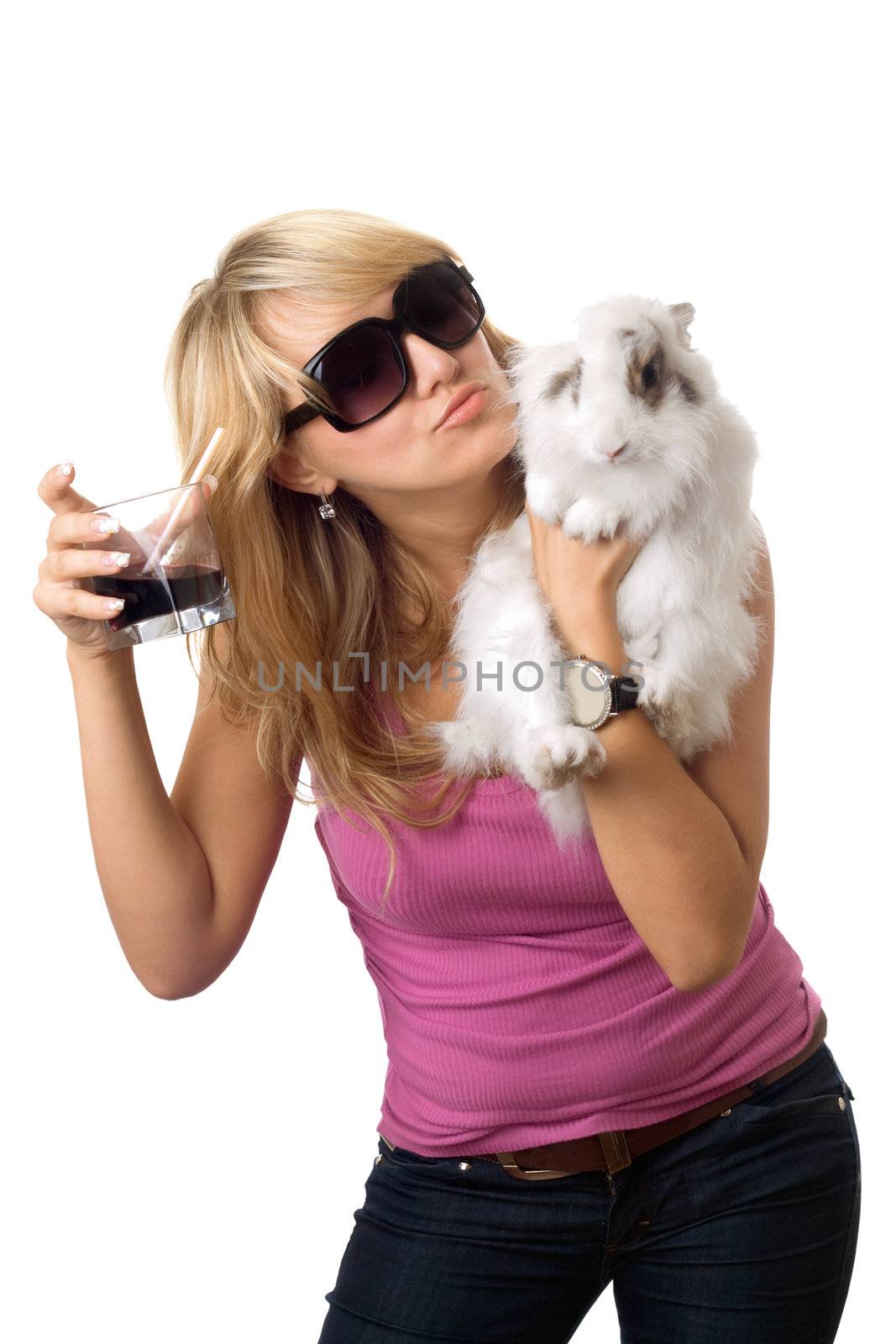 Playful young woman with a glass of drink and little rabbit. Isolated