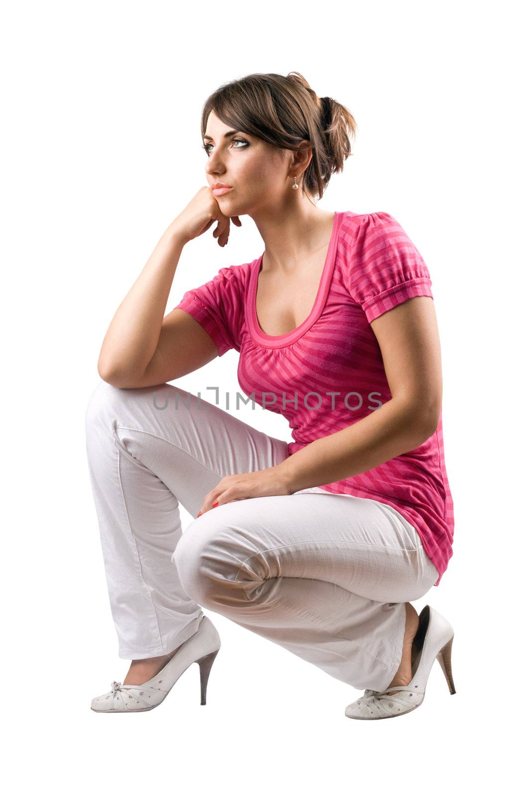 Thoughtful pretty woman in the squatting position. Isolated
