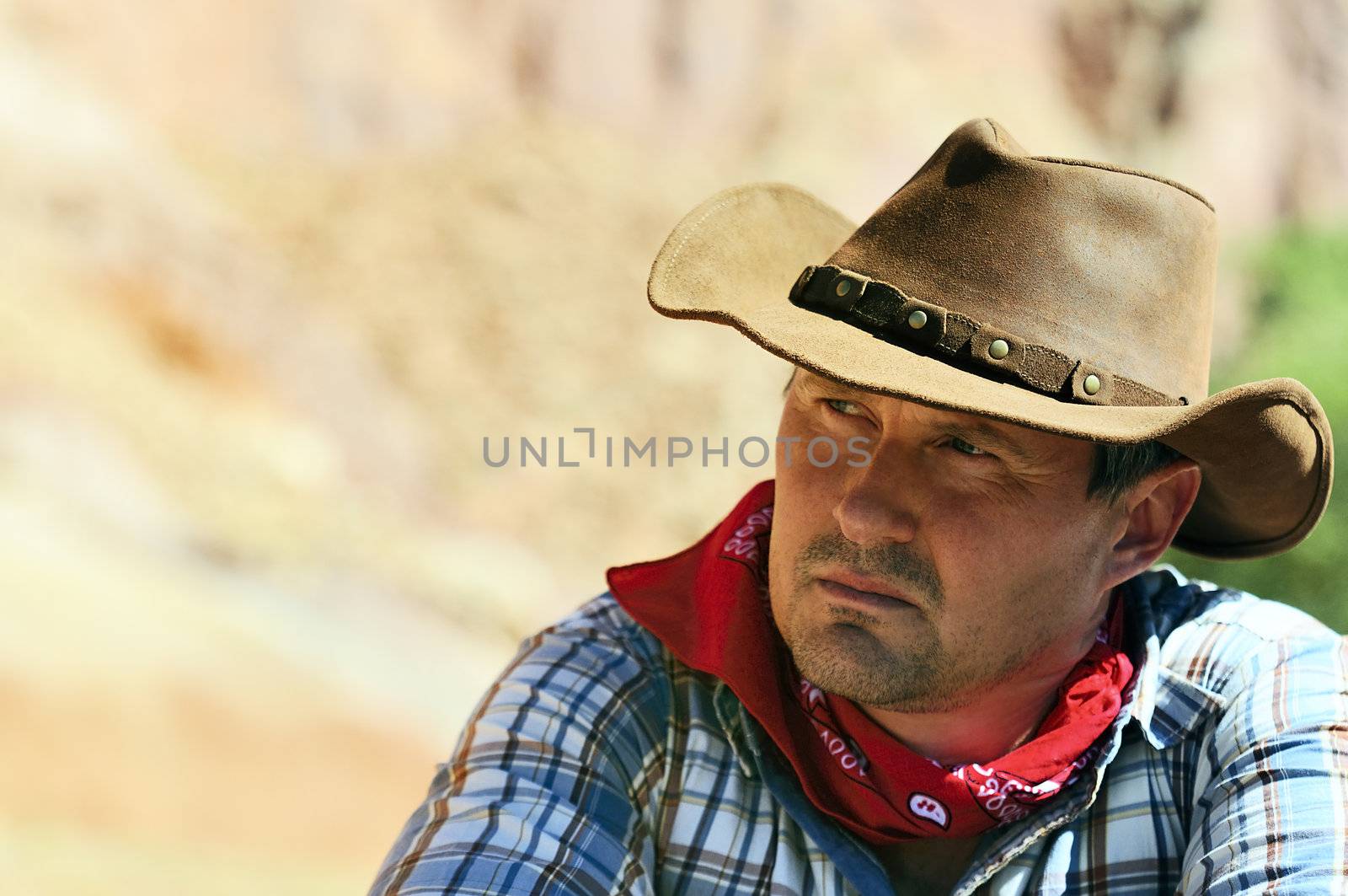 OUT WEST - A cowboy takes time to rest and reflect. 