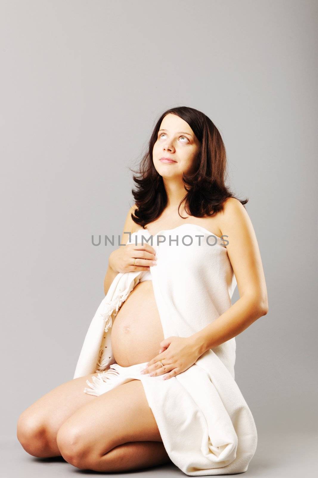 Portrait of a sitting pregnant woman 
