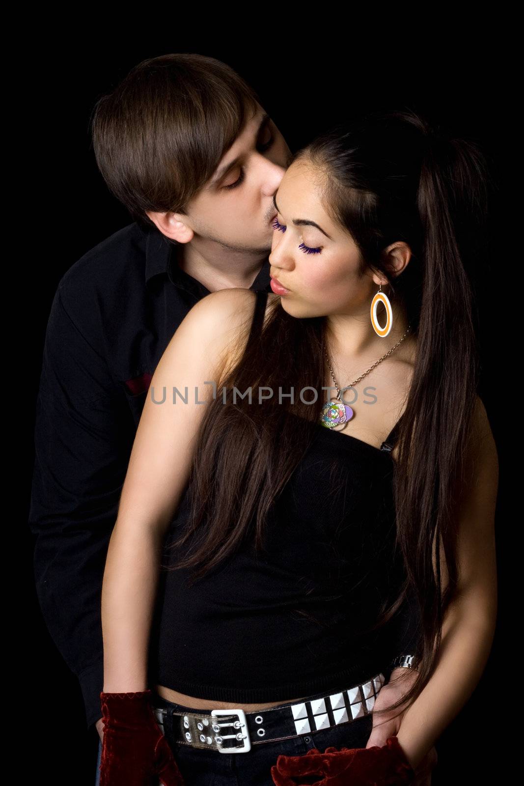 Portrait of young passionate pair. Isolated on black