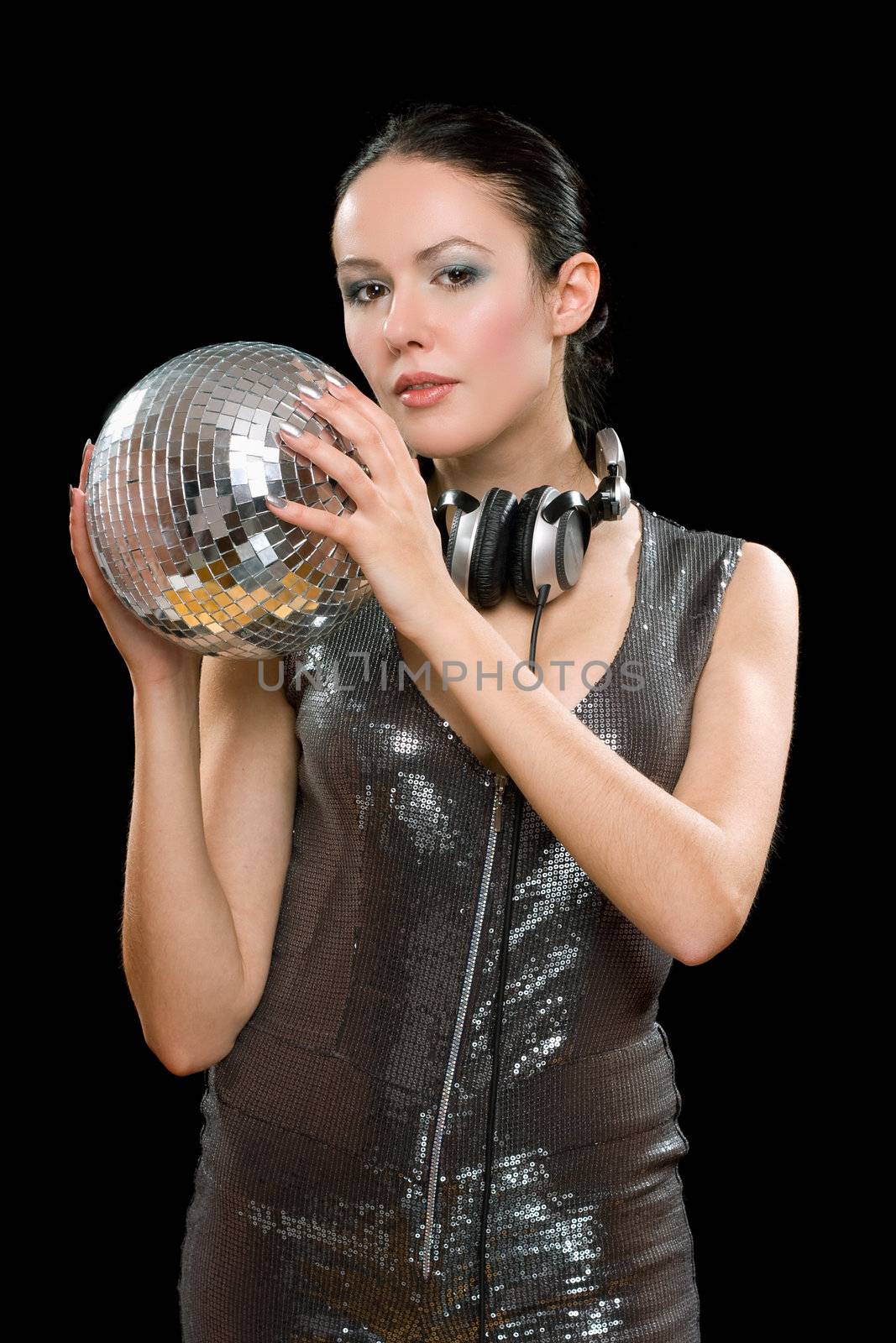 Portrait of young woman with a mirror ball in her hands. Isolated on black