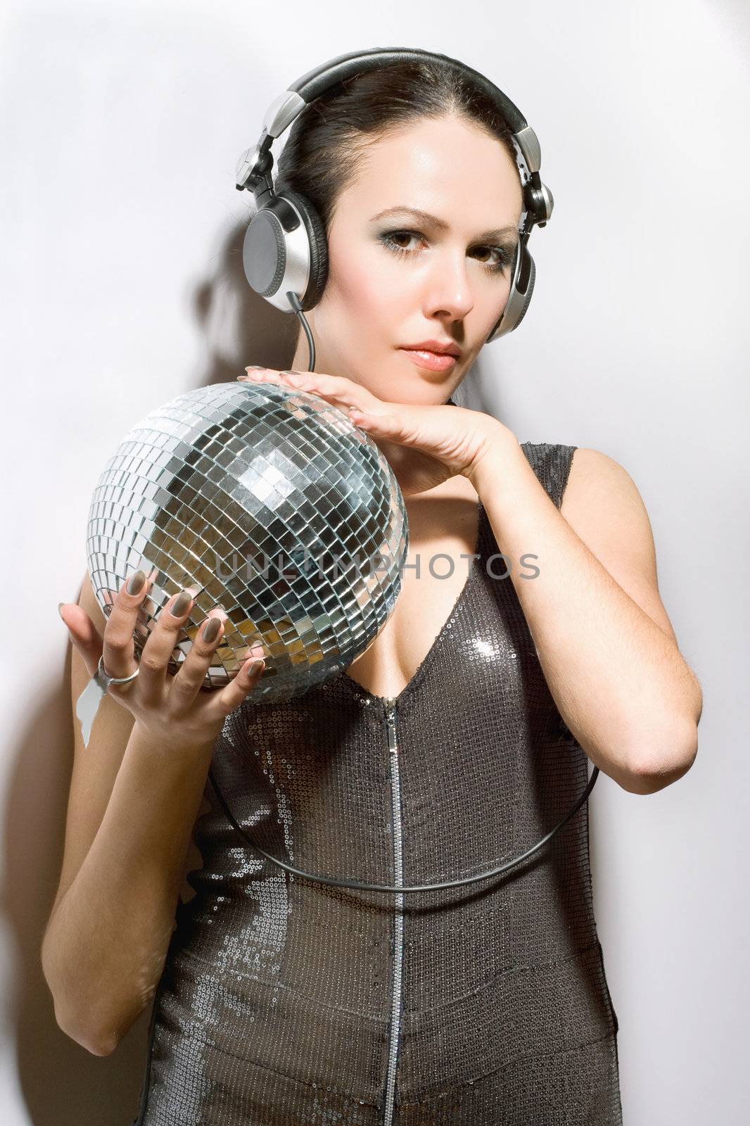 Portrait of beautiful brunette with a mirror ball in her hands