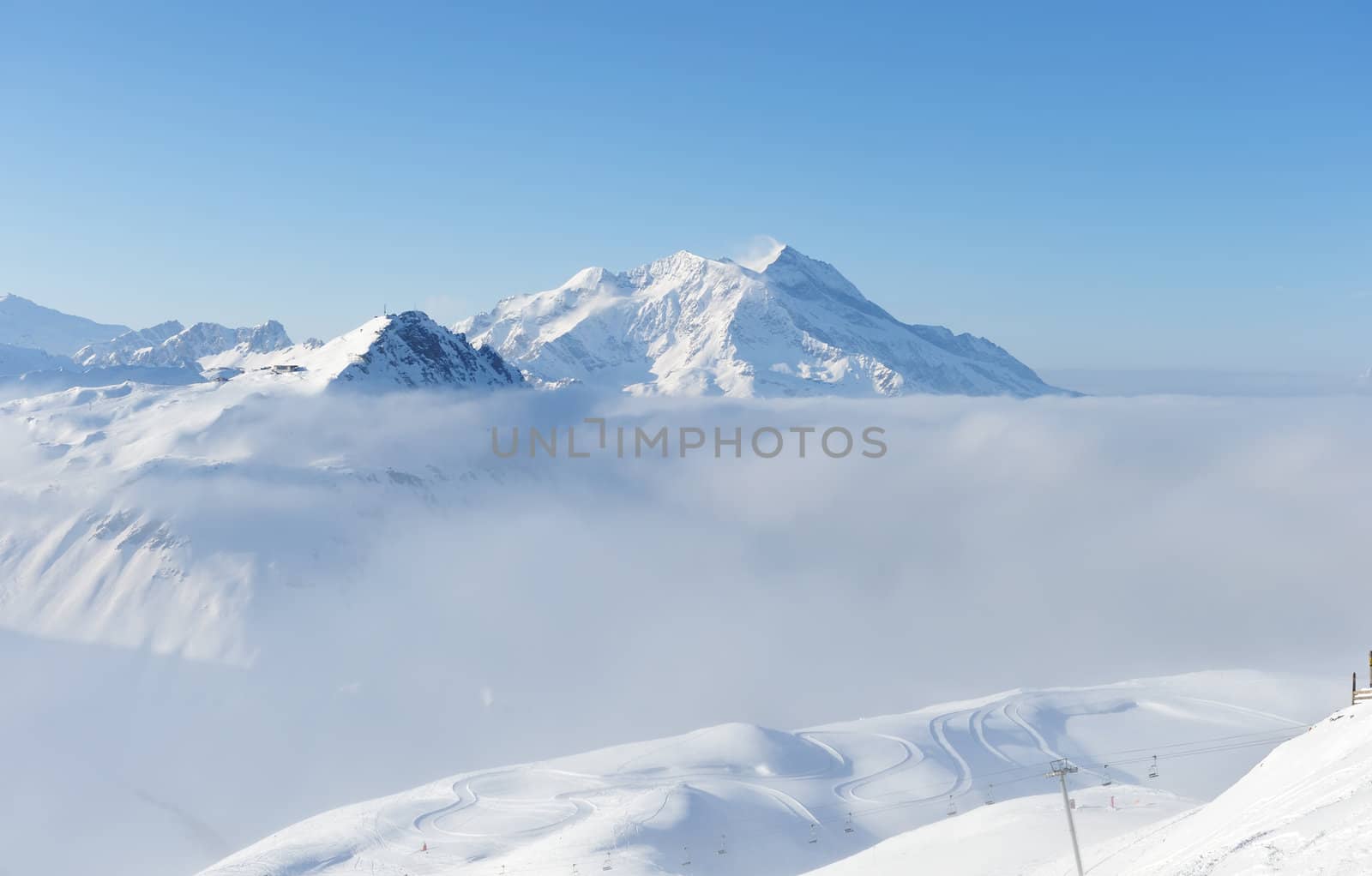 Mountains in clouds with snow in winter, Val-d'Isere, Alps, France
