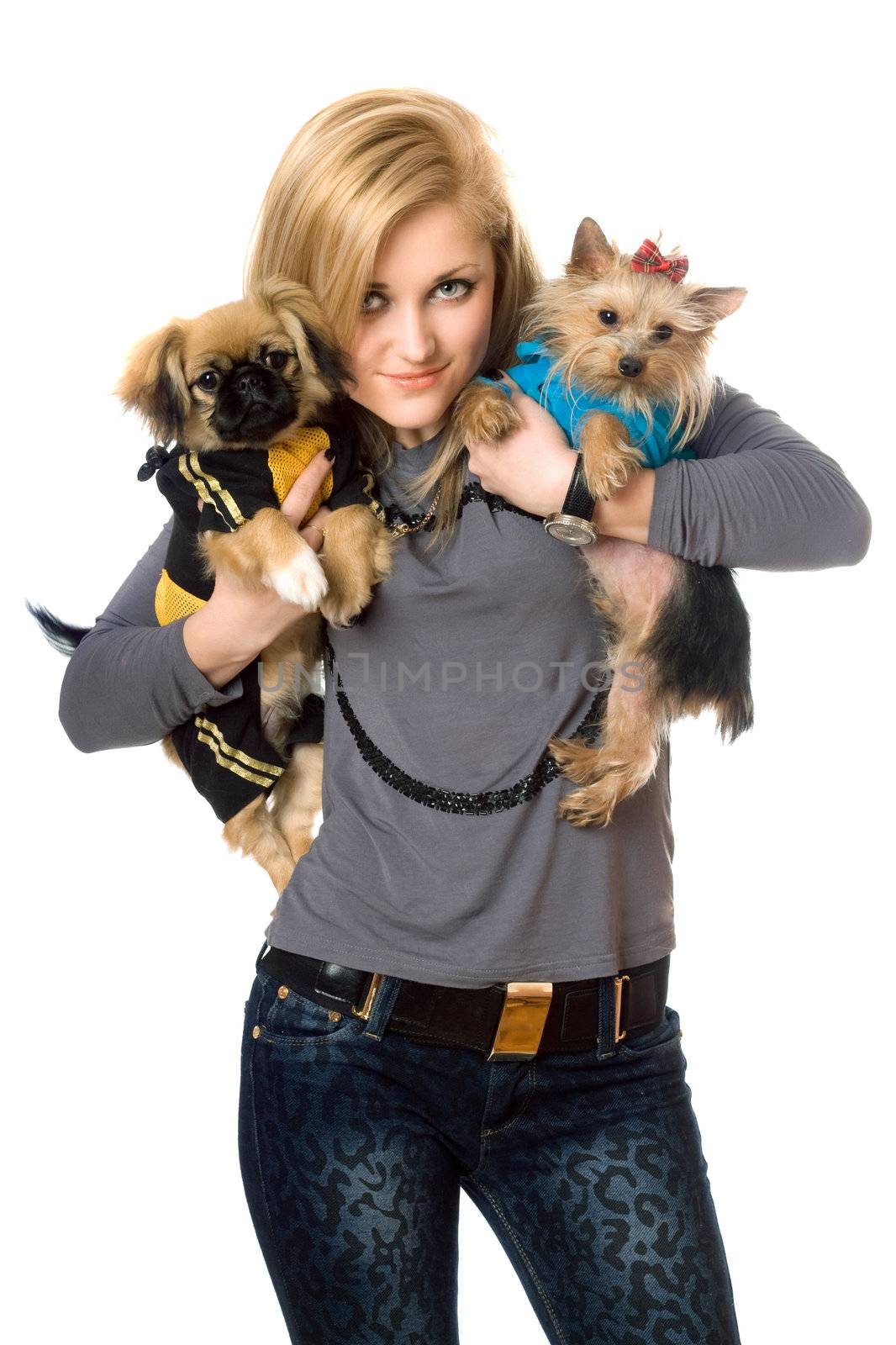Smiling young blonde posing with two dogs. Isolated