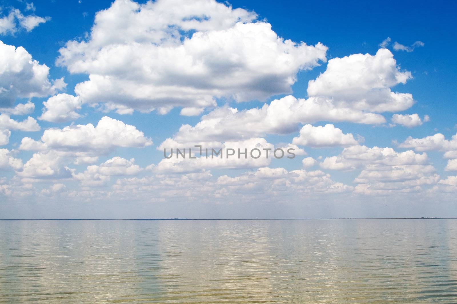 The blue sky and clouds over a sea bay by acidgrey