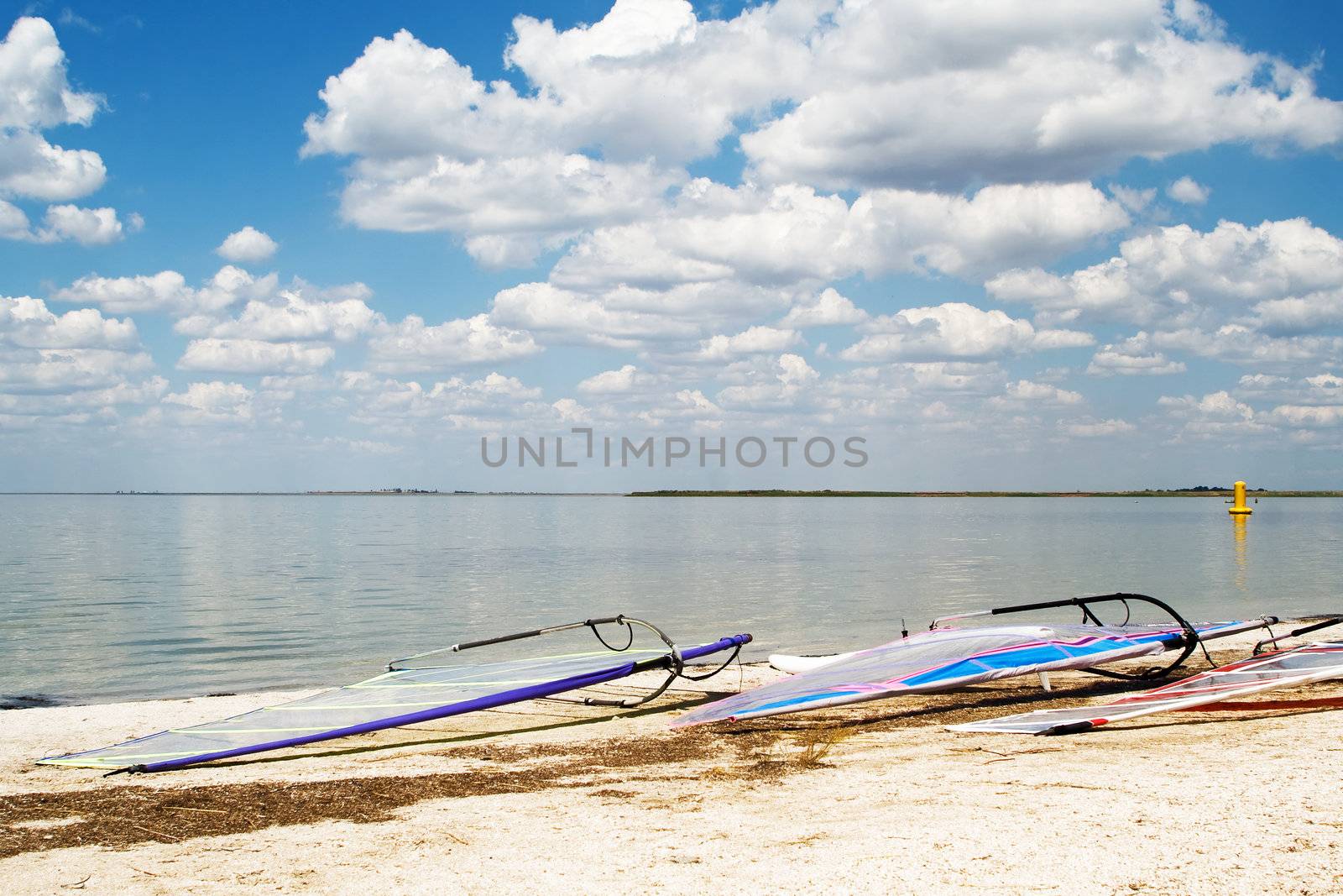 Surfboards on a beach a sea bay on background of the blue sky an by acidgrey