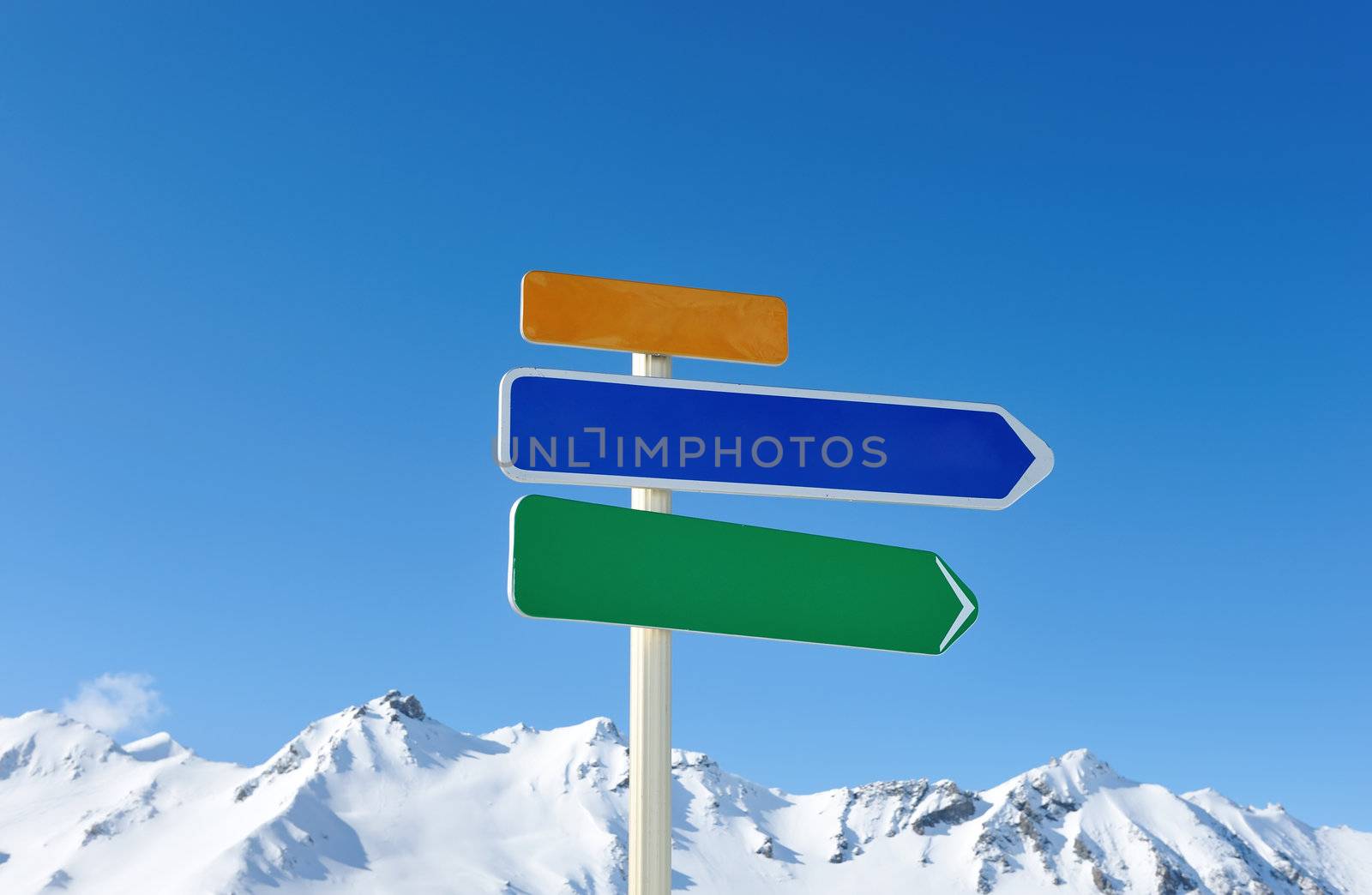 Arrow sign at mountains with snow in winter, Val-d'Isere, Alps, France