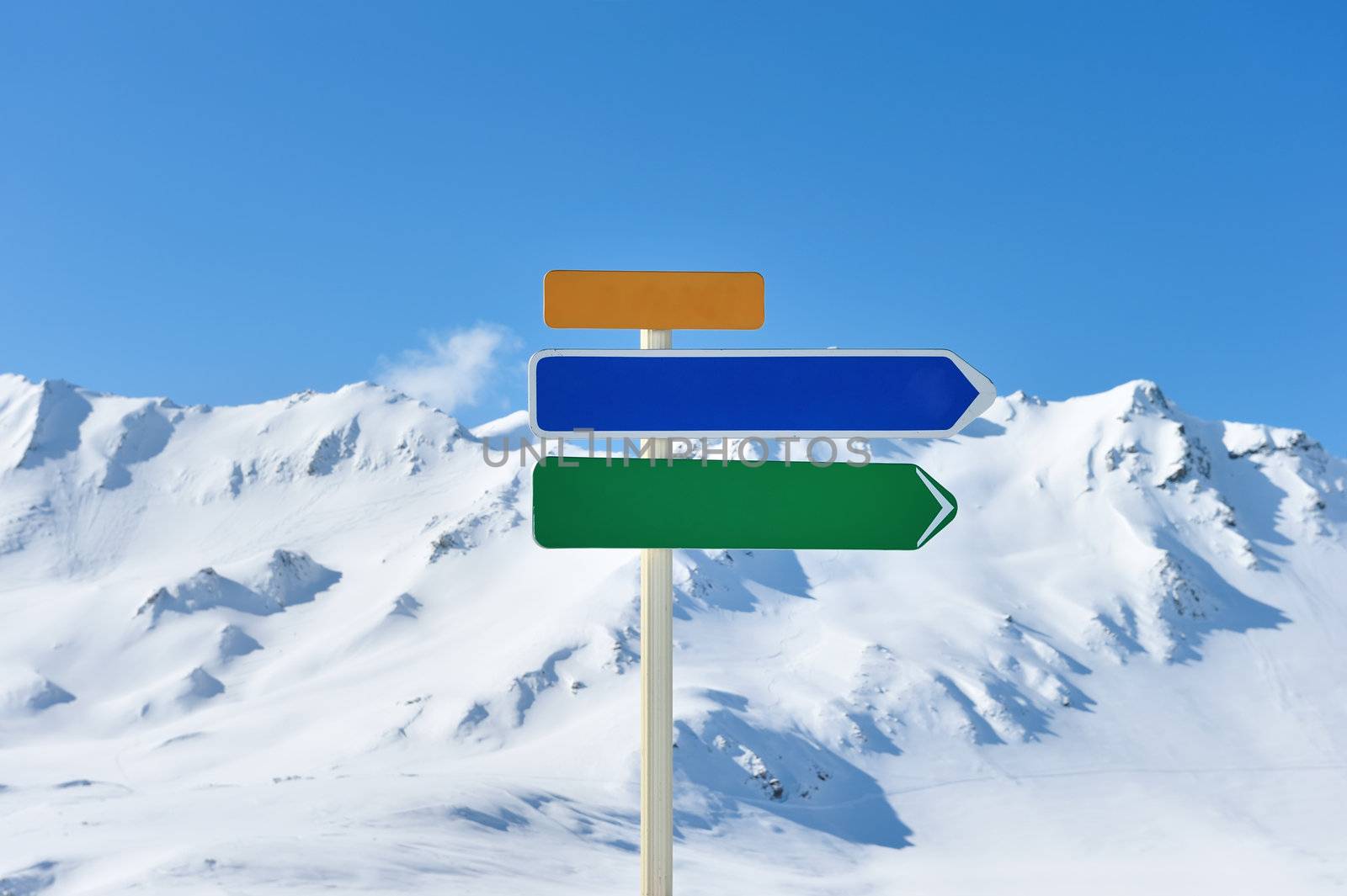 Arrow sign at mountains with snow in winter, Val-d'Isere, Alps, France
