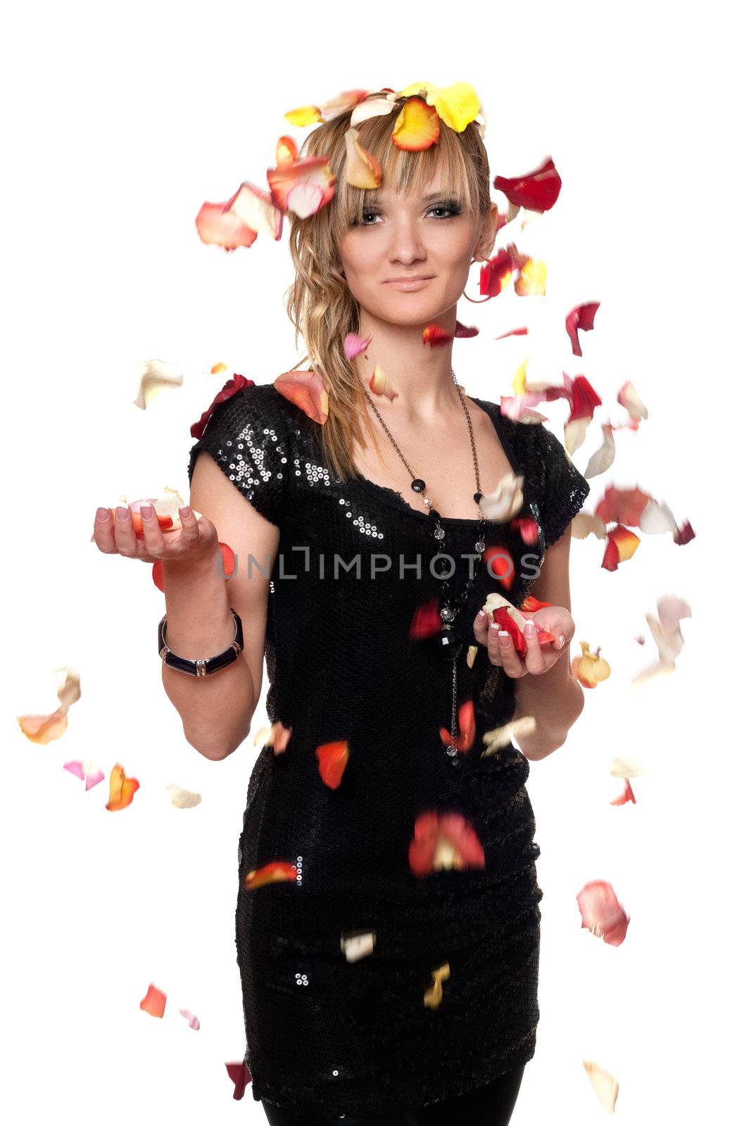 Portrait of young blonde in the falling rose petals