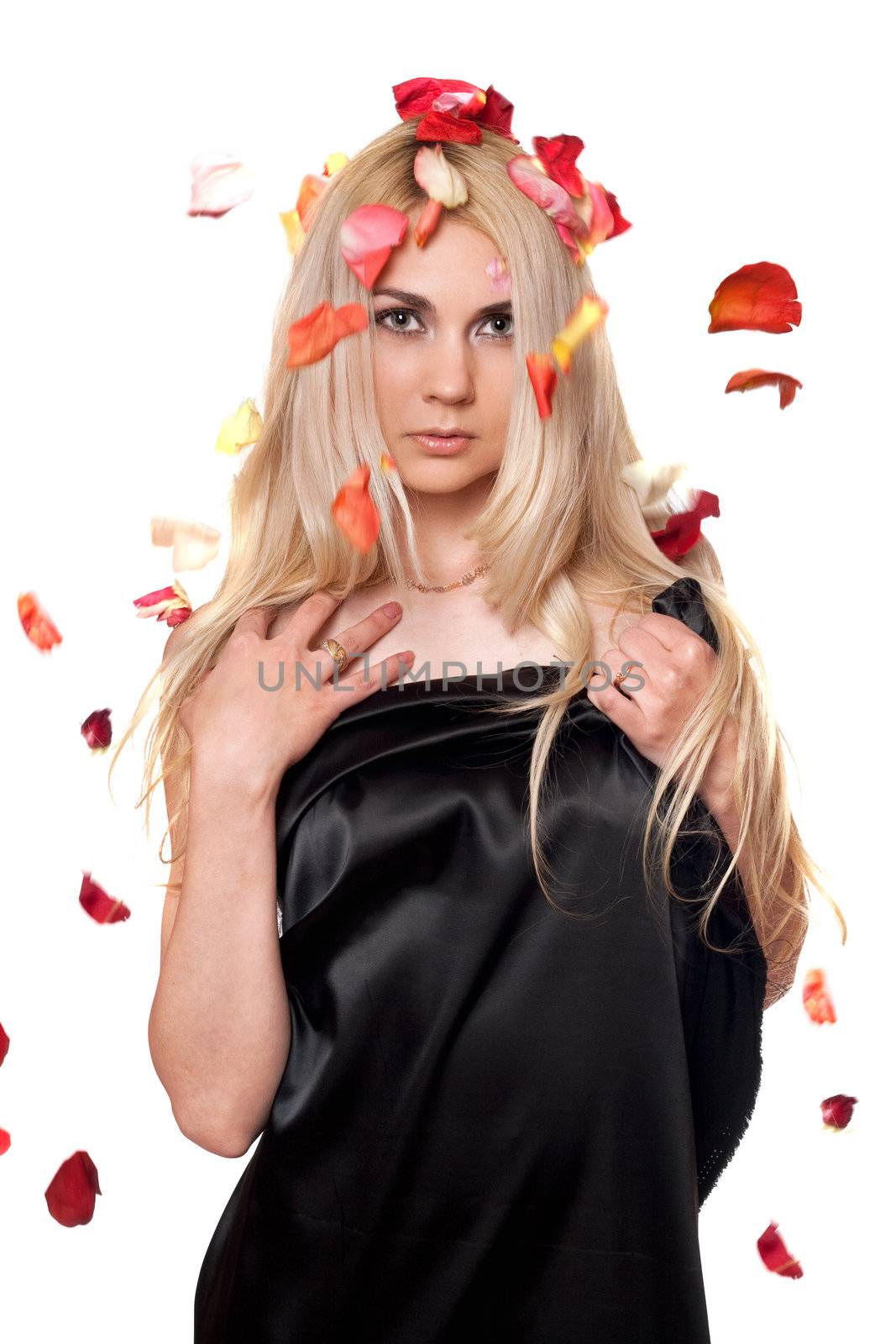 Portrait of pretty blonde in the falling rose petals