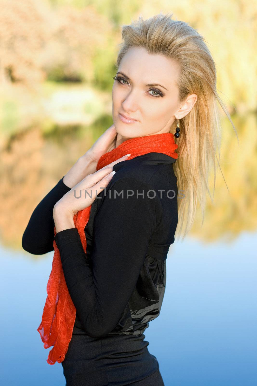 Portrait of a young pretty blonde in autumn park
