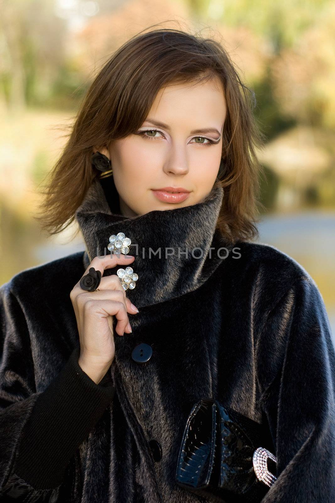 Portrait of a attractive young woman in autumn park