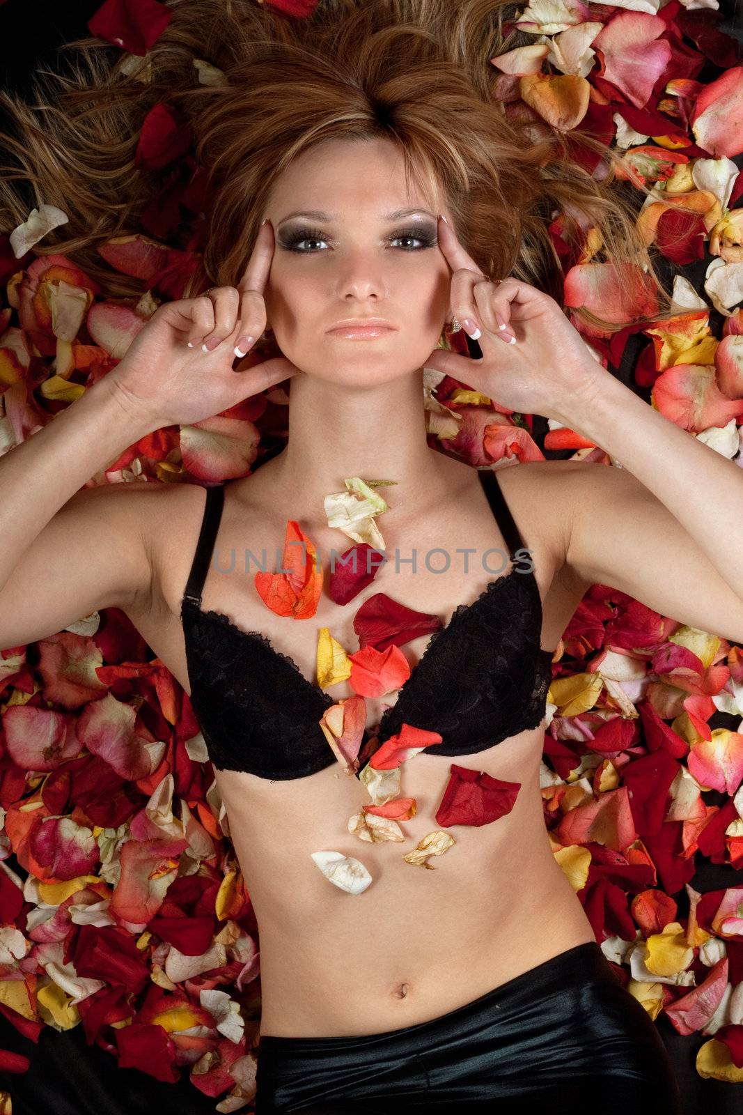 sensual blonde lying in rose petals by acidgrey