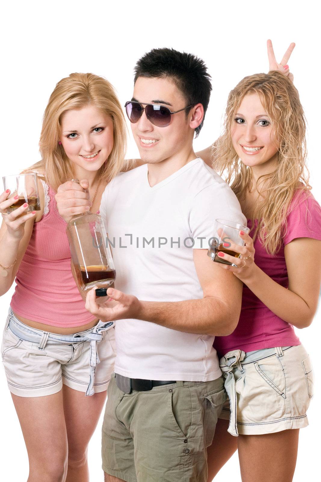 Two cheerful blonde woman and young man with a bottle