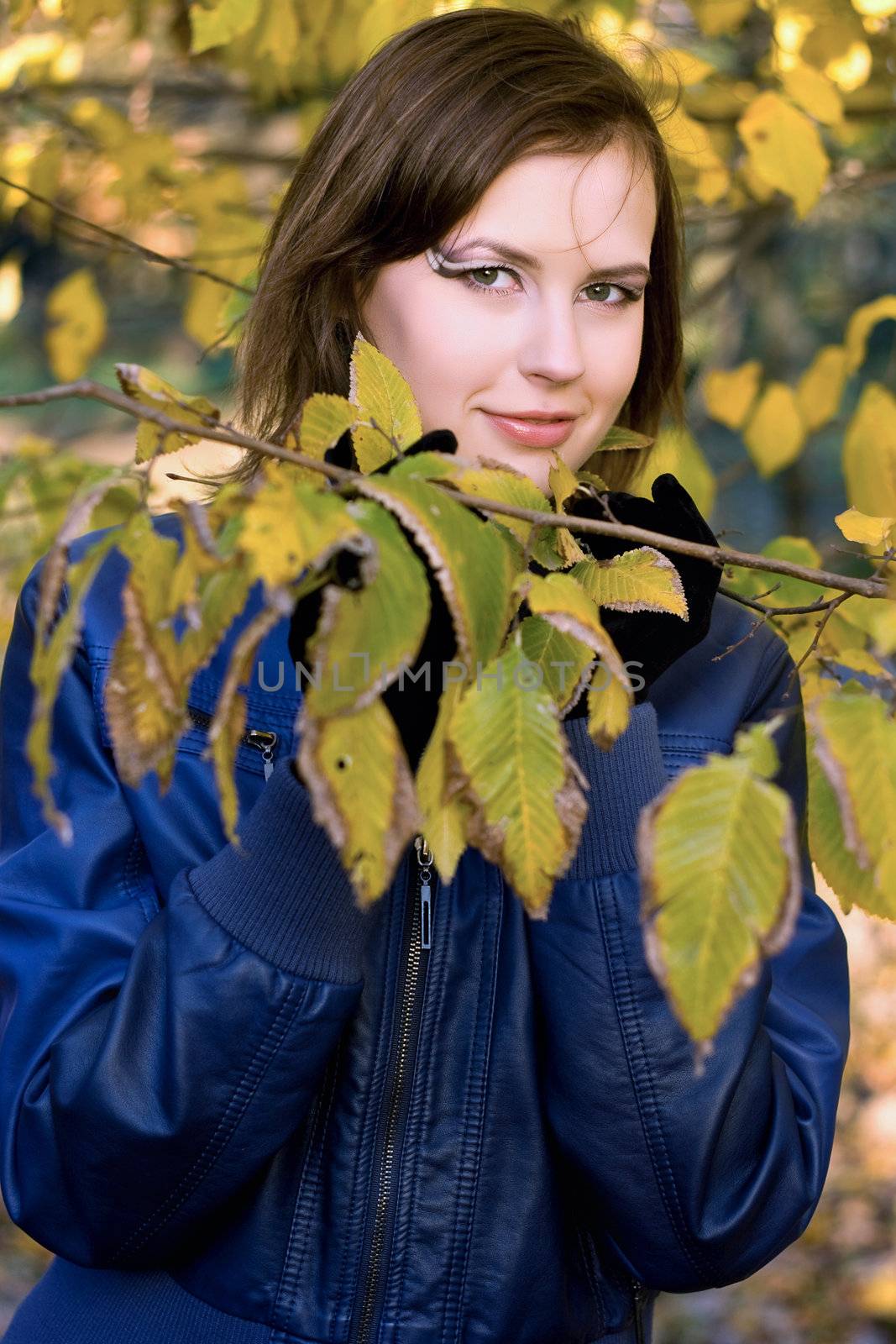 Portrait of a smiling girl amongst the autumn leaves
