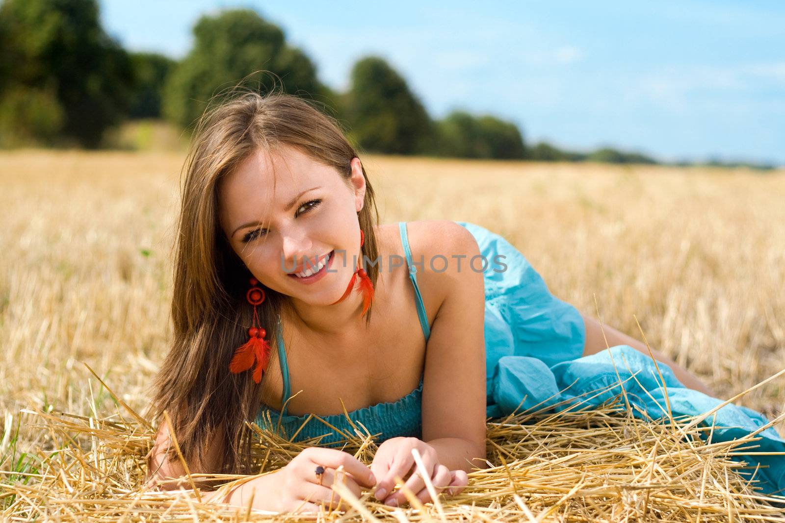 Portrait of young woman lying in the field