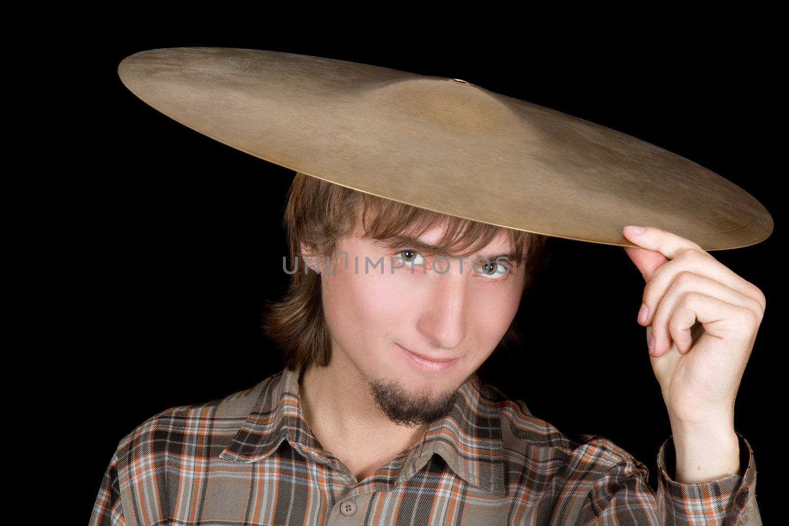 The young man with a plate from a drum on a head