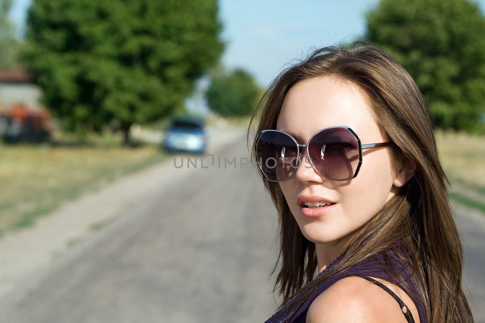 Portrait of beautiful young brunette on the road