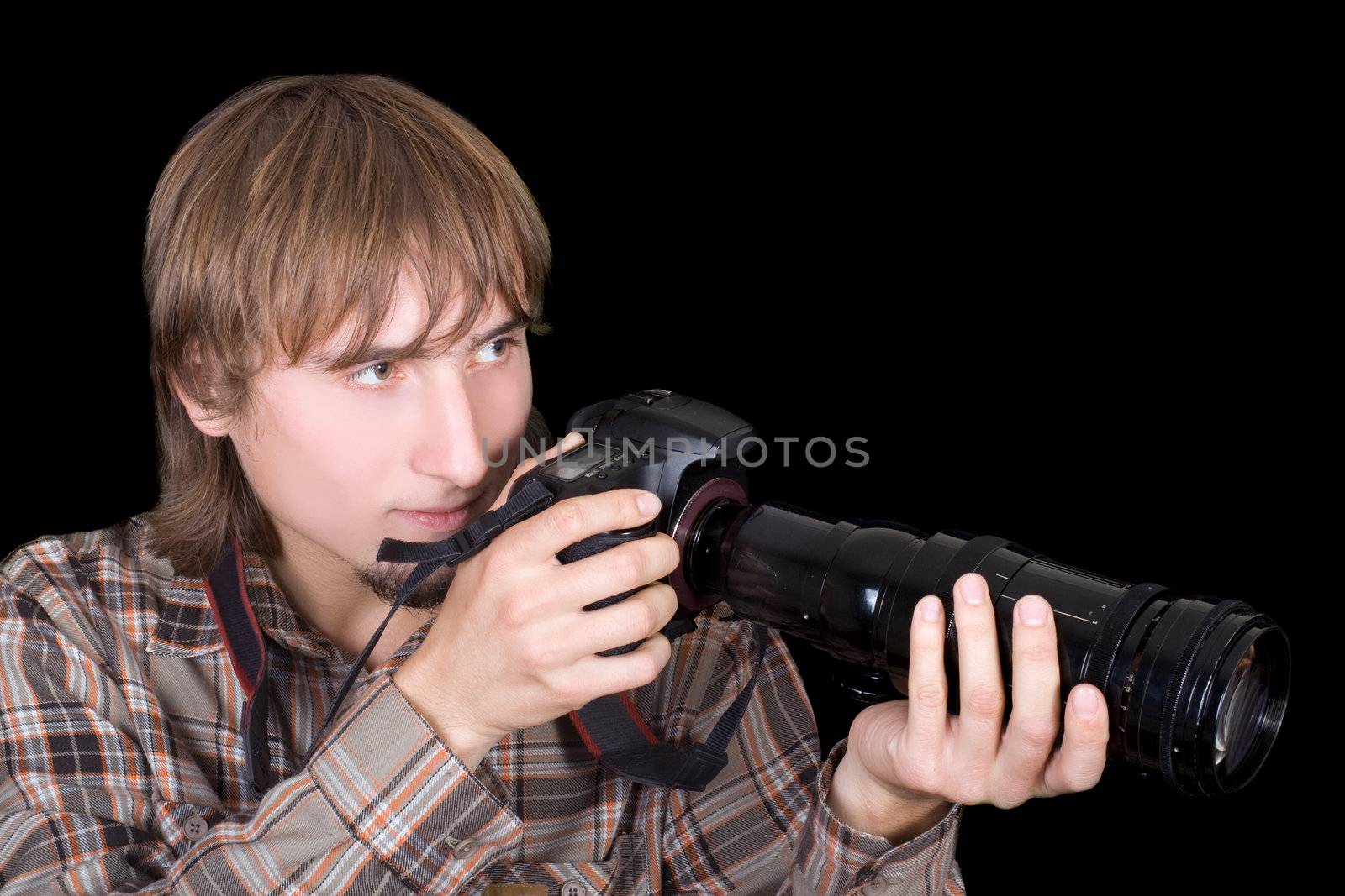 Young  photographer with the camera with a zoom lens