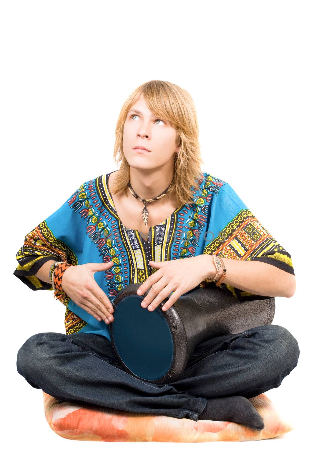 The young man plays a drum looking upwards