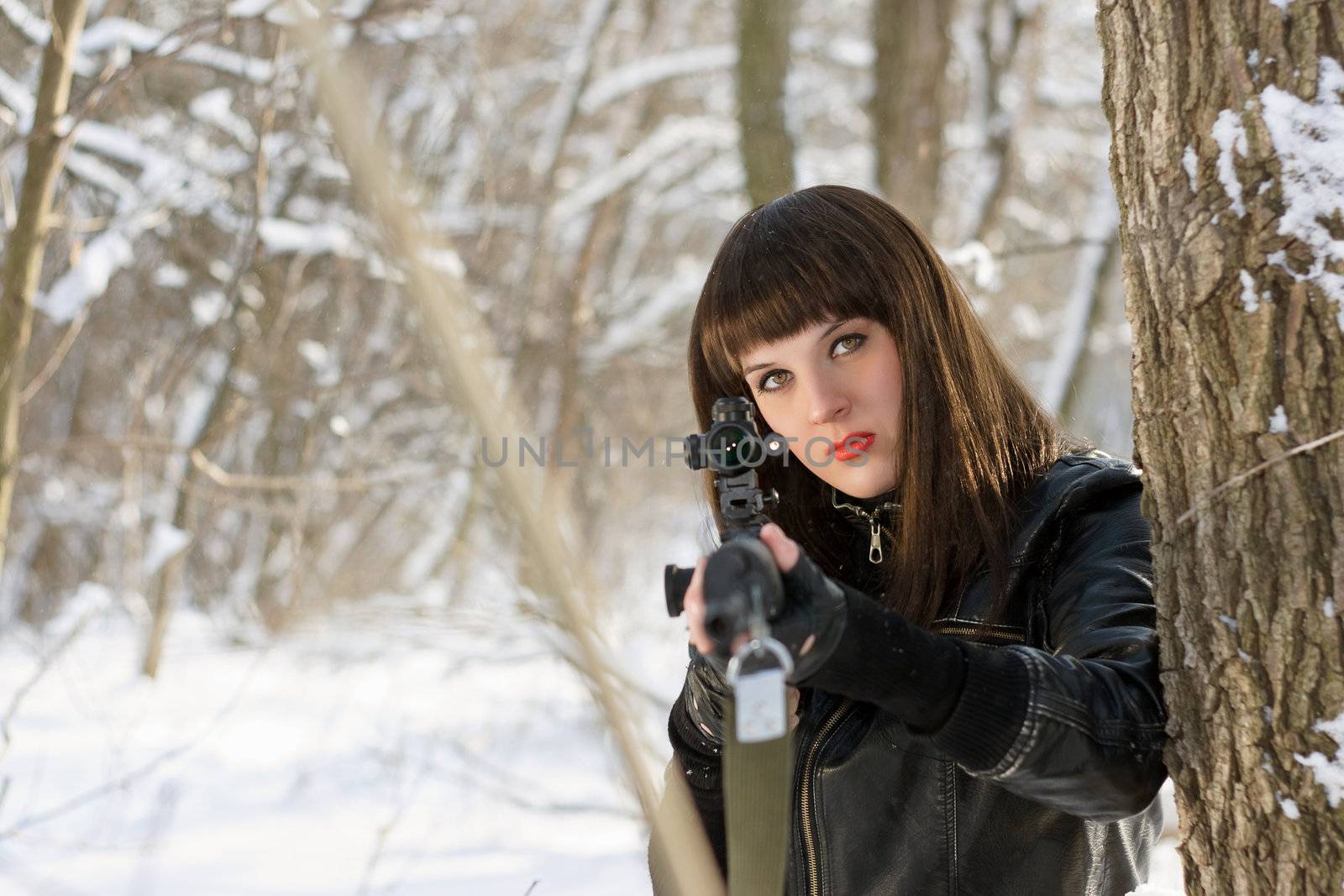 Portrait of gorgeous young woman with a sniper rifle 