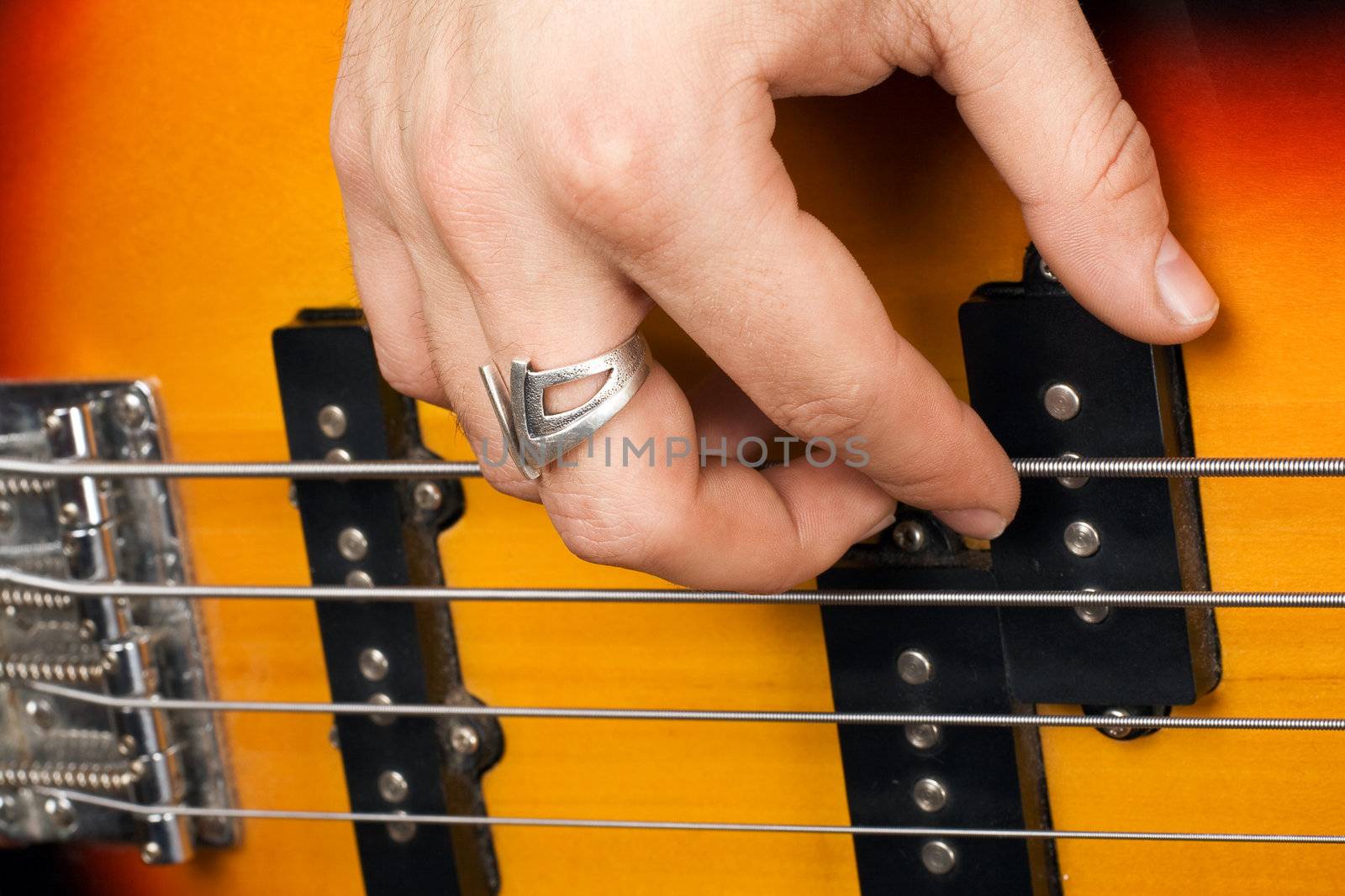 Hand of the guitarist on guitar strings