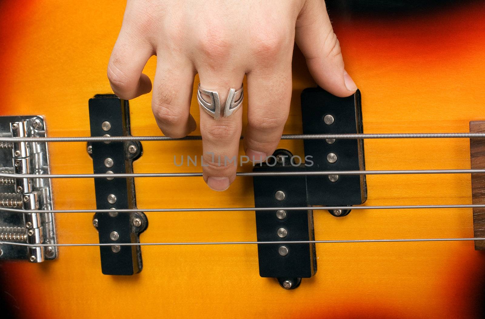 Hand of the artist on guitar strings