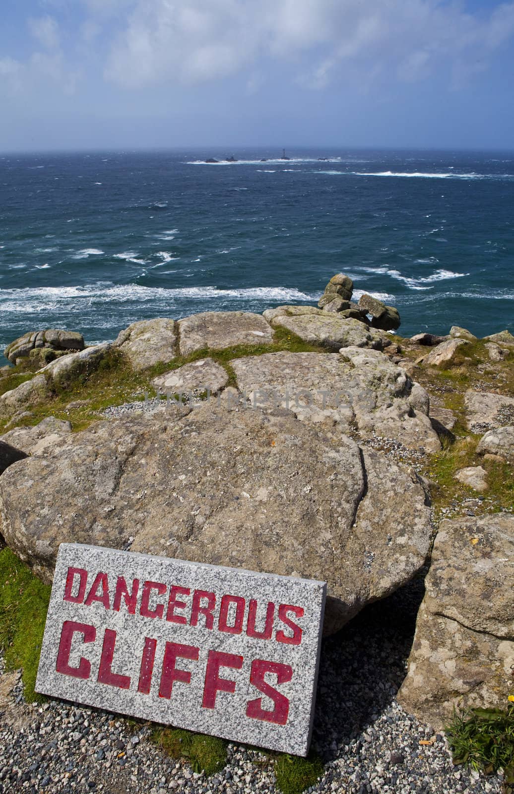 Dangerous Cliffs at Land's End in Cornwall, England.  The Longships Lighthouse can be seen in the distance.